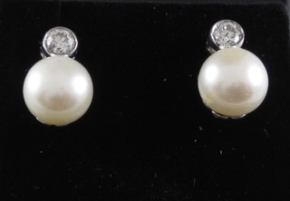 A pair of diamond and pearl set earrings, approx 0.40ct