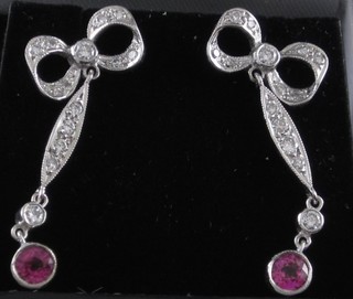 A pair of lady's 18ct white gold ribbon drop earrings, set diamonds and rubies, approx 0.50ct