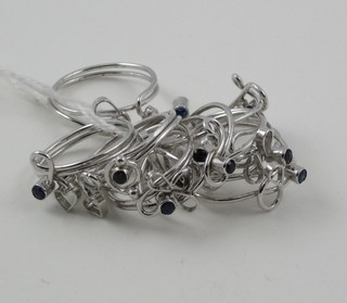 12 various Eastern silver dress rings set blue stones