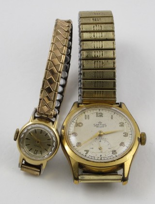 A gentleman's Smiths Delux wristwatch contained in a gold plated case and a lady's Timex wristwatch