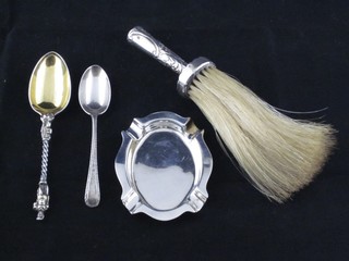 An oval silver ashtray, a silver handled brush and 2 silver teaspoons