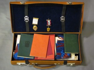 A leather attache case containing a quantity of Scots Masonic regalia comprising tartan apron, Royal Arch companions apron and sash, a Mark Master Masons jewel and a Scots Royal Arch Masons jewel