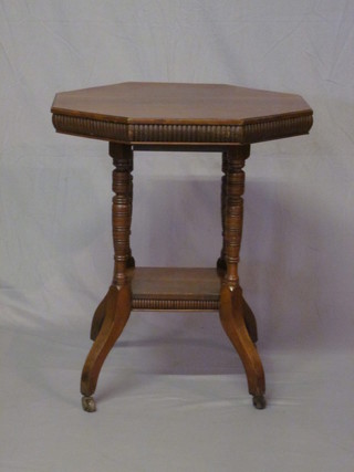 An Edwardian octagonal mahogany table, raised on turned and  reeded supports with undertier 27"
