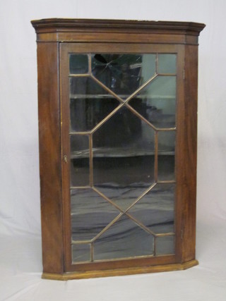 A 19th Century mahogany corner cabinet with moulded cornice,  fitted shelves and enclosed by astragal glazed panelled doors 33"