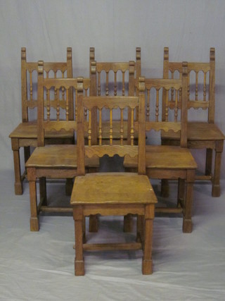 A set of 6 Continental elm high back dining chairs with bobbin turned decoration and solid seats, raised on square supports with  H framed stretcher