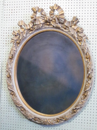 An oval plate mirror contained in a decorative frame 32"
