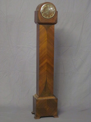 An Art Deco chiming Granddaughter clock with silvered dial and Arabic numerals, contained in a walnut case 57"
