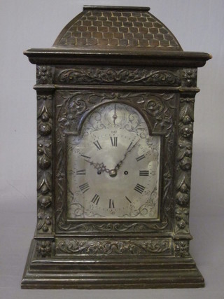 A Victorian 8 day striking double fusee bracket clock with 7" plain brass back plate, the 8 1/2" silvered arched dial with  engraved spandrels and strike/silent indicator, contained in a  heavily carved oak case ILLUSTRATED