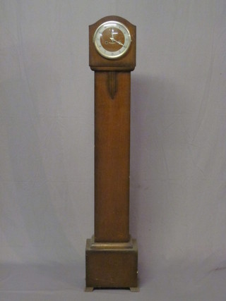 A 1930's striking Granddaughter clock with silvered dial  contained in an oak case 55"