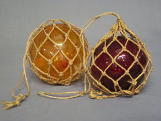 2 red and amber glass fishing floats