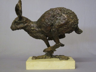 Hamish Mackie, a bronze figure of a running hare, signed and  dated '98, raised on a marble base, 21" ILLUSTRATED