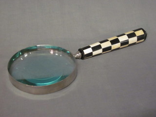 A large magnifying glass with chequered patterned handle 14"