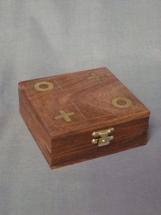 A square Eastern hardwood noughts and cross game with hinged lid 4" wooden