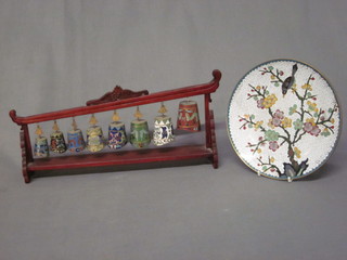 A circular white glazed cloisonne enamelled plate decorated birds 7", together with 8 graduated cloisonne bells, raised on a  hardstone stand