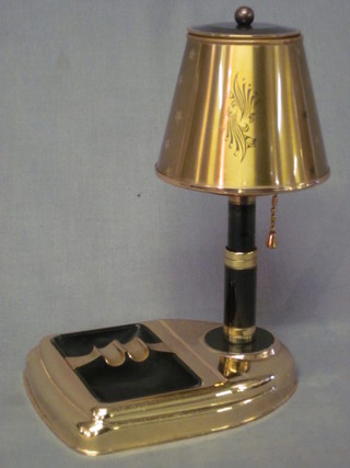 A 1950's gilt and black enamelled metal cigarette dispenser/ashtray in the form of a table lamp 9"