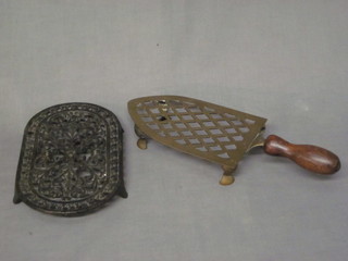 A pierced brass iron stand and an oval pierced iron trivet 8"