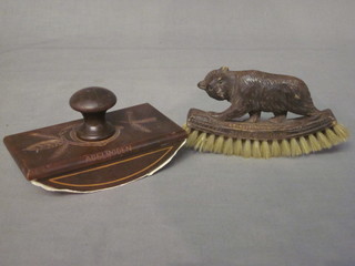 A Victorian carved wooden desk blotter together with a wooden brush with carved wooden handle decorated a bear, both marked  Aldeboden