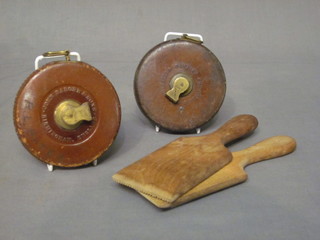 A pair of wooden butter pats together with 2 surveyors tape  measures by John Rayborne & Chesterman of Sheffield