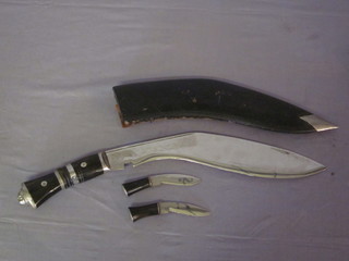 A Kukri with 2 skinning knives contained in a leather scabbard