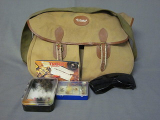 A canvas and leather fishing bag by Bob Church of Nottingham containing a small collection of fishing accessories