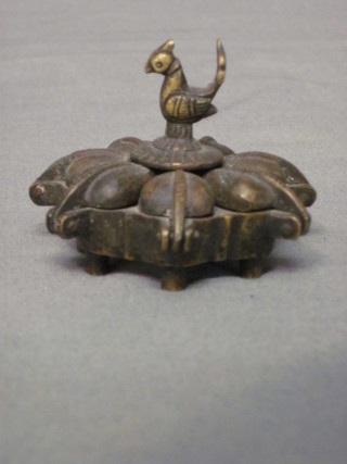 A circular Eastern bronze trinket box having 7 spade shaped segments with bird finial, 2"