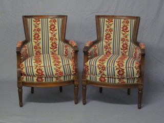 A pair of mahogany show frame armchairs upholstered in  stripped material