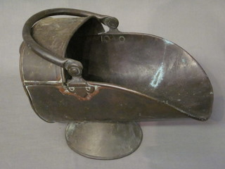 A Victorian copper helmet shaped coal scuttle