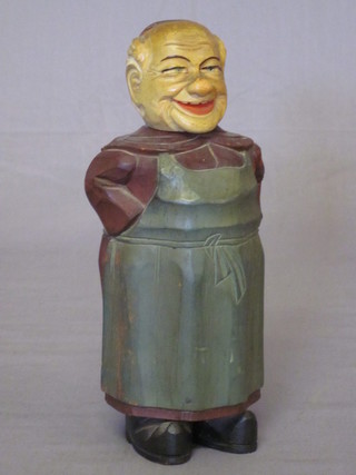 A WWII glass flask contained in a carved wooden case in the  form of a standing monk, made by Prisoners of War, the base  marked RRC POW, 8"