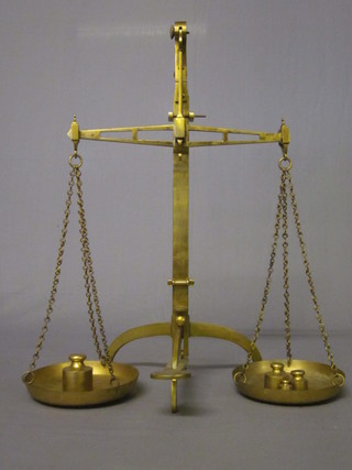 A pair of brass scales by W & T Avery together with 5 George V  brass bell weights - 20 ozs, 10 ozs, 5 ozs, 2 ozs and 3 ozs  ILLUSTRATED