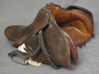 A leather hunting saddle complete with stirrups by A J Barnsby  & Sons