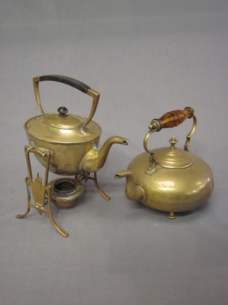 An Art Nouveau brass kettle raised on 3 bun feet together with an Art Nouveau tea kettle and stand