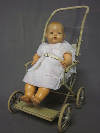 A childs metal framed push chair by Cumfifolda containing a  plastic doll