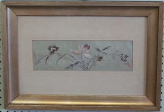 An embroidered silk panel depicting flowers 3" x 9 1/2"