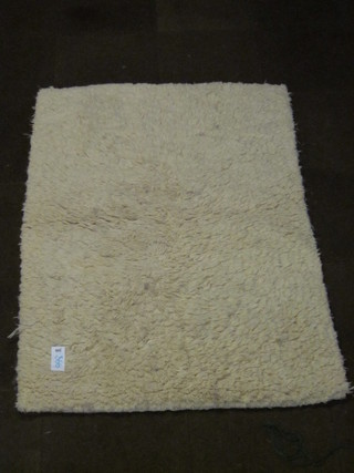 A white ground deep pile rug 65" x 46"
