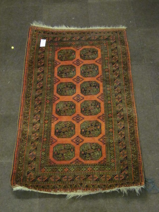 A pink ground Afghan rug with 12 octagons to the centre 74" x  41"