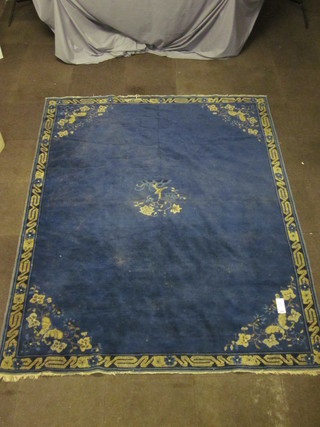 A 1930's blue ground Chinese carpet with floral decoration,  some wear, 101" x 78"