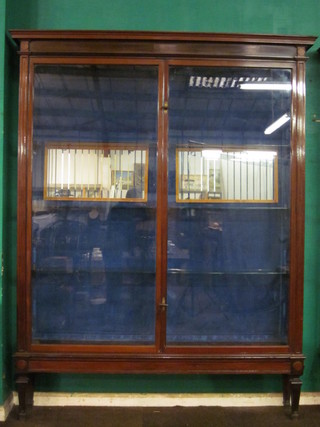 A handsome Edwardian mahogany shop display cabinet with  glazed shelved interior enclosed by glazed panelled doors, raised  on square tapering supports by Pollard Shore Fitters of London  71" x 90"