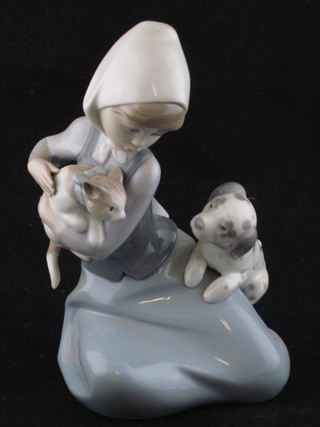 A Lladro figure of a seated girl, base marked 5032 7 1/2", boxed ILLUSTRATED