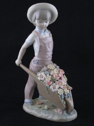 A Lladro figure of a standing boy with wheel barrow, base  marked 1283, 10"