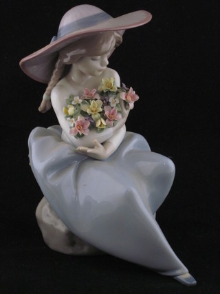 A Lladro figure of a seated girl with garland of flowers, base  marked 5962, 8"