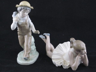 A Nao figure of a walking boy 7 1/2" and a Nao figure of a reclining girl 8"