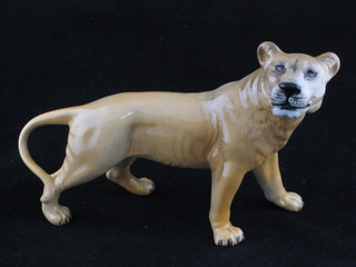 A Beswick figure of a walking lion, 9"