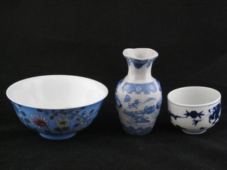 An Oriental porcelain rice bowl 6", 1 other Oriental blue and  white bowl 2" and a club shaped vase 5"
