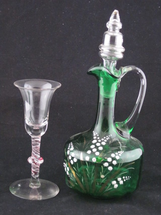 A Victorian green glass ewer and stopper with enamelled  decoration 8" and a bell shaped wine glass with cotton twist stem