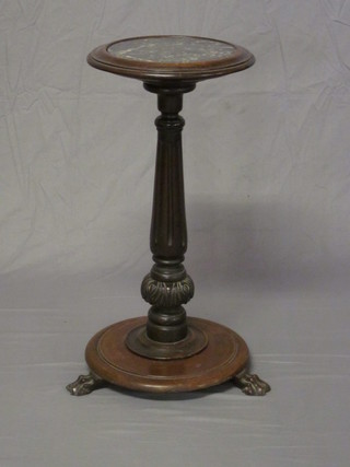 A Victorian circular fluted mahogany torchere with black veined marble top, raised on a turned and fluted column