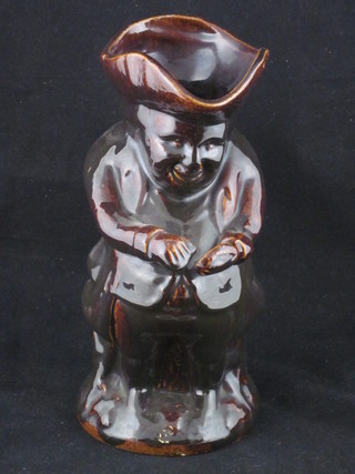 A 19th Century brown treacle glazed Toby jug in the form Toby Philpot taking snuff, 10"