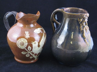 An Art Pottery jug, the base marked D Norman 7", together with  1 other Art Pottery vase, the base marked Charles Brannham 1880 and with iron handle 6"