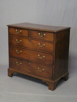 A Georgian mahogany chest with crossbanded top, fitted 2 short  and 3 long drawers with brass swan neck drop handles, raised on  bracket feet 35" ILLUSTRATED