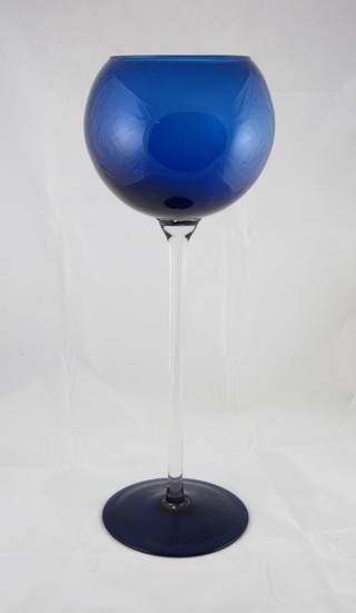 A large blue decorative blue glass wine glass with clear glass  stem 15"