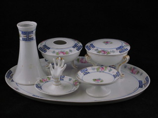 A Noritake 6 piece porcelain dressing table set comprising oval tray, ring tree, hair tidy, hatpin stand, dish and cover and dish  